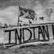 Reminiscent of graffiti on Alcatraz Island, Indian Land is written across a concrete divider. Dividers were used as barricades to stop water protectors nearing construction of the DAPL pipeline. Image courtesy of Alex Flett.